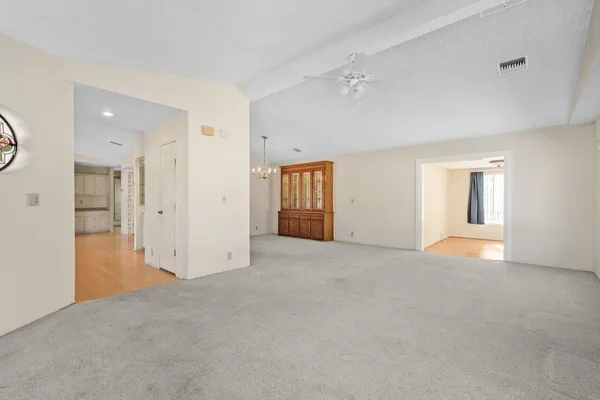 an empty room with windows and bathroom