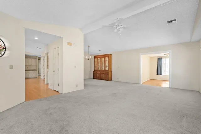 an empty room with windows and bathroom