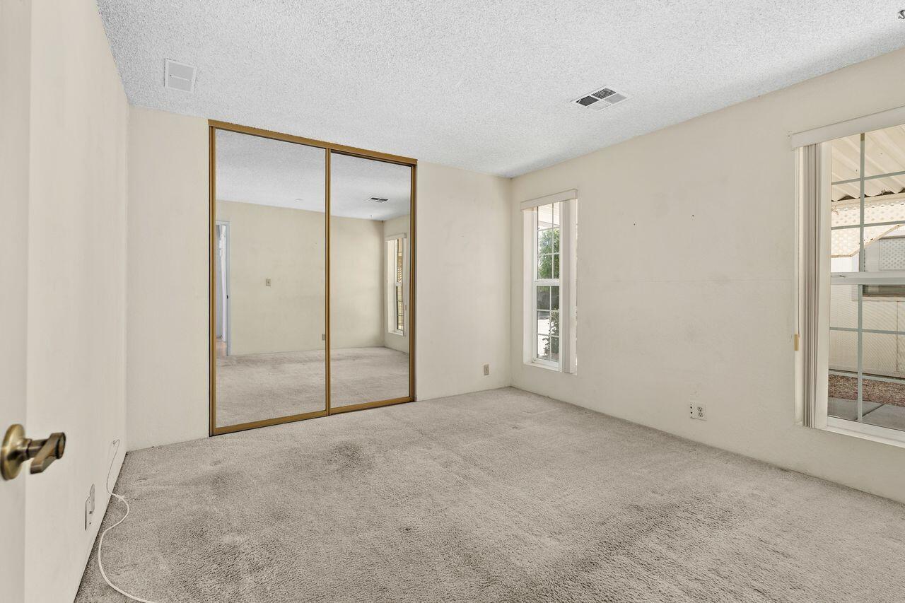 47857 Prado Way Indio, CA 92201 - Photo 22 of 36 an empty room with windows and closet