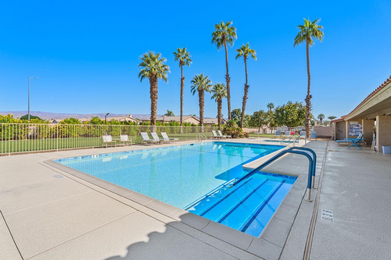 47857 Prado Way Indio, CA 92201 - Photo 33 of 36 a view of a swimming pool with a lounge chairs
