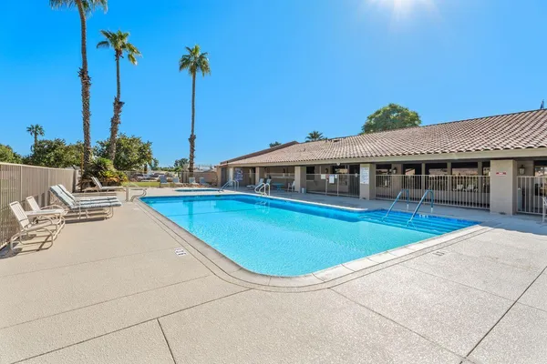 a view of a swimming pool with a lounge chairs