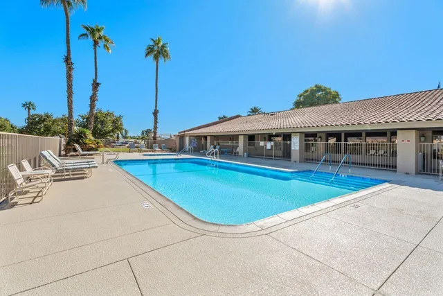 a view of a swimming pool with a lounge chairs
