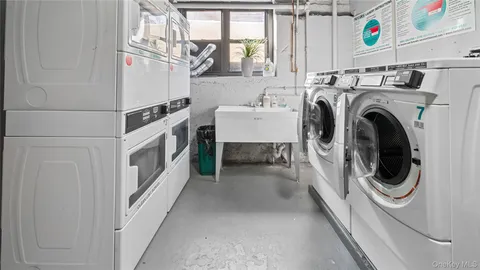a roof deck with a table and a potted plants