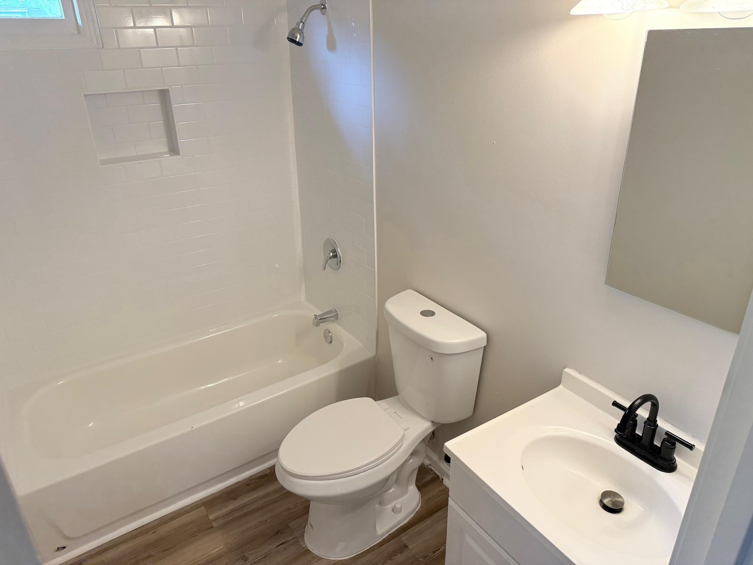 5657 Raleigh Lagrange Road Memphis, TN 38134 - Photo 4 of 8 Full bath with toilet, wood finished floors, bathtub / shower combination, and vanity