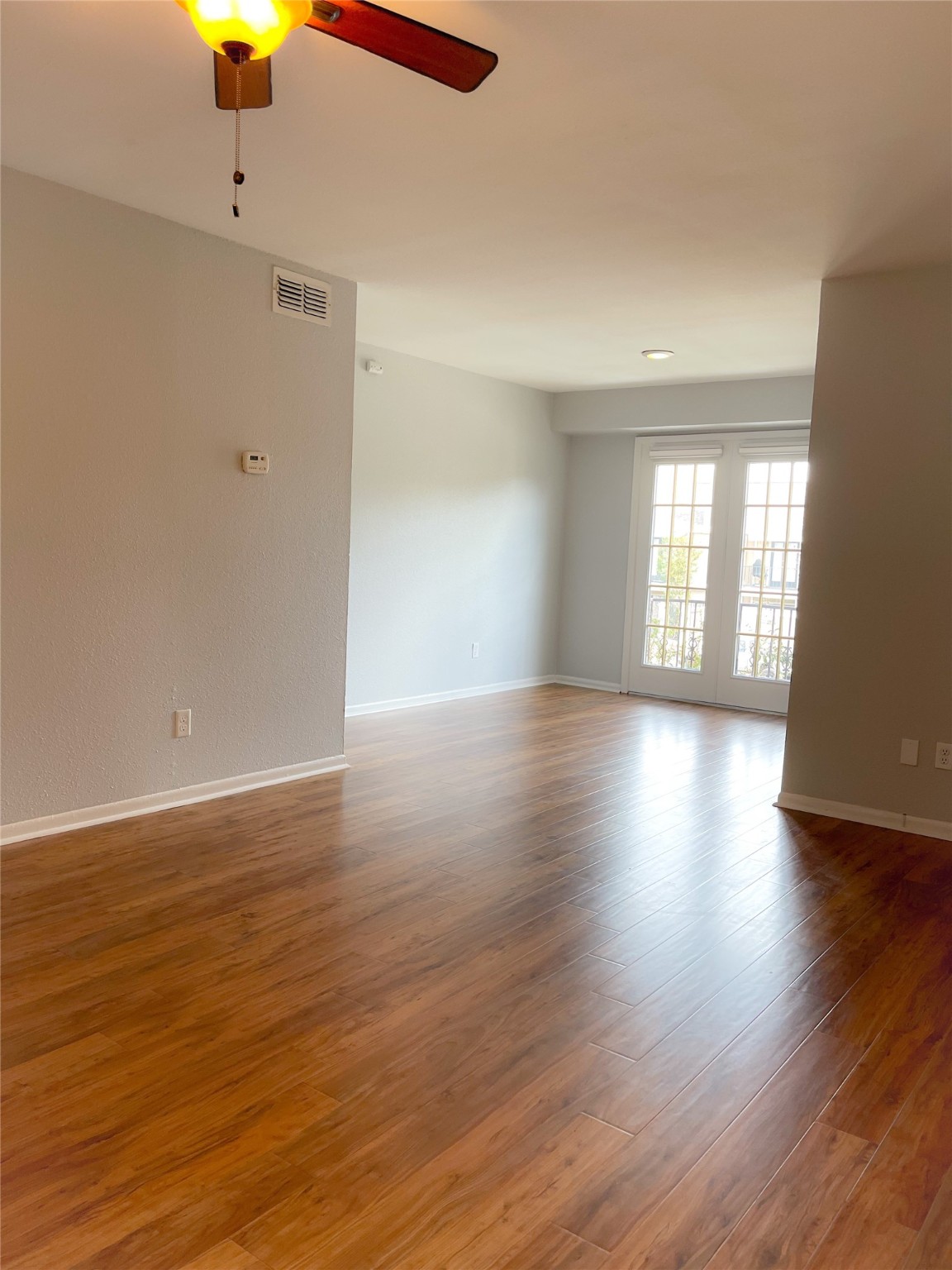 2744 Briarhurst Drive, Unit 50 Houston, TX 77057 - Photo 10 of 23 a view of an empty room with window and wooden floor