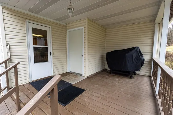 a view of front door of a house with wooden floor
