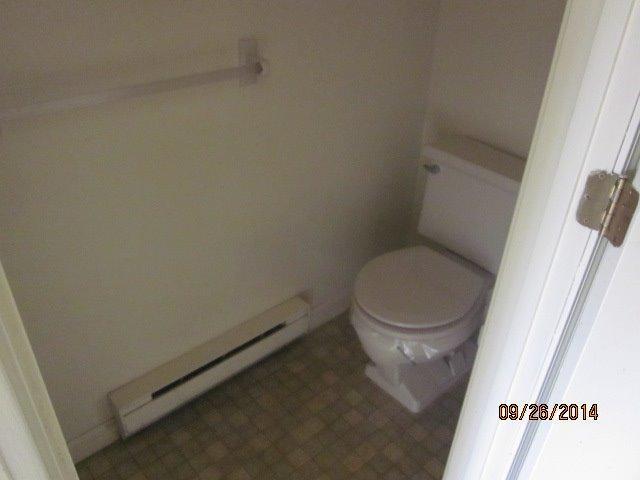 110 West Main Street, Unit 15 Hyannis, MA 02601 - Photo 6 of 10 a white toilet sitting next to a sink