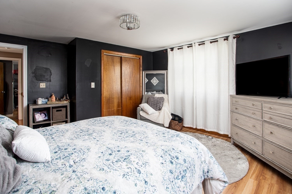 425 Pearce Street Fall River, MA 02720 - Photo 28 of 33 a bedroom with a bed and a flat screen tv in it