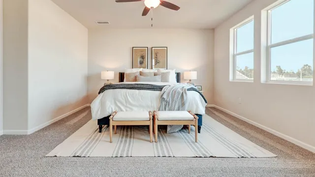 a view of a bedroom with furniture and window