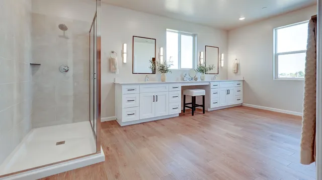 a bathroom with a sink a mirror a bathtub and shower