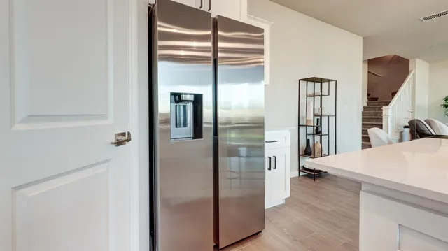a view of a kitchen from a hallway