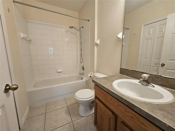 a bathroom with a sink a toilet a mirror and shower