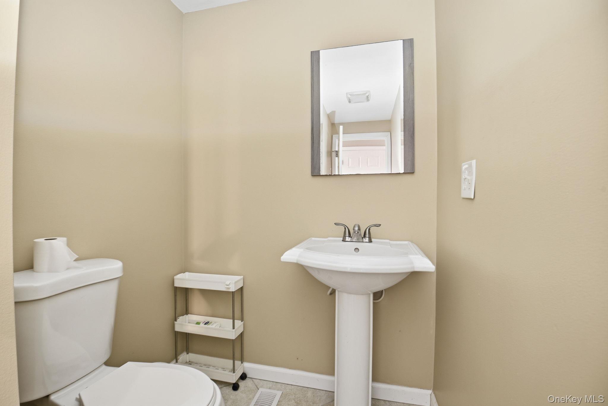 35 Shady Creek Road Pleasant Valley, NY 12569 - Photo 17 of 33 a bathroom with a sink a mirror and a toilet