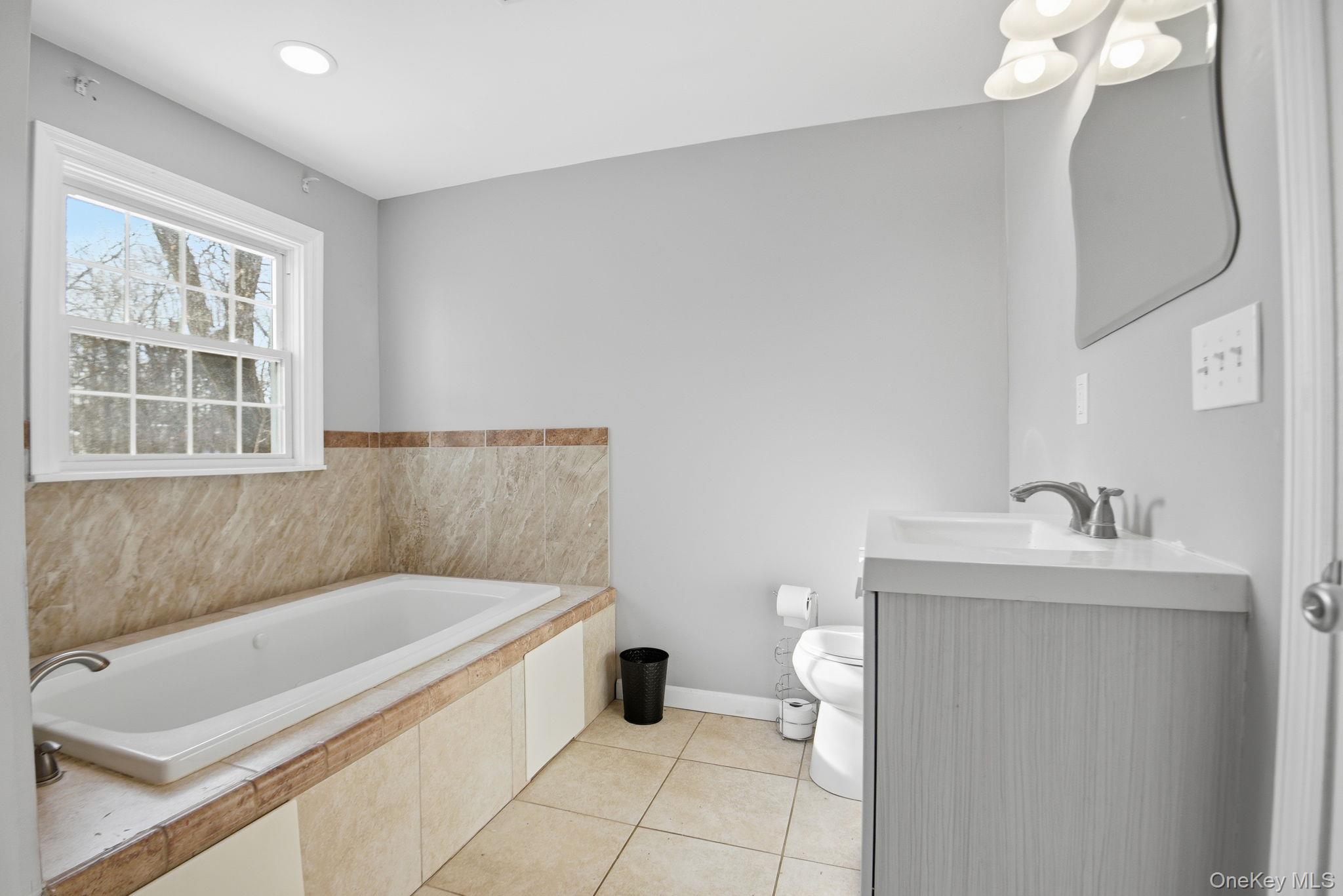 35 Shady Creek Road Pleasant Valley, NY 12569 - Photo 21 of 33 a bathroom with a bathtub sink vanity and toilet