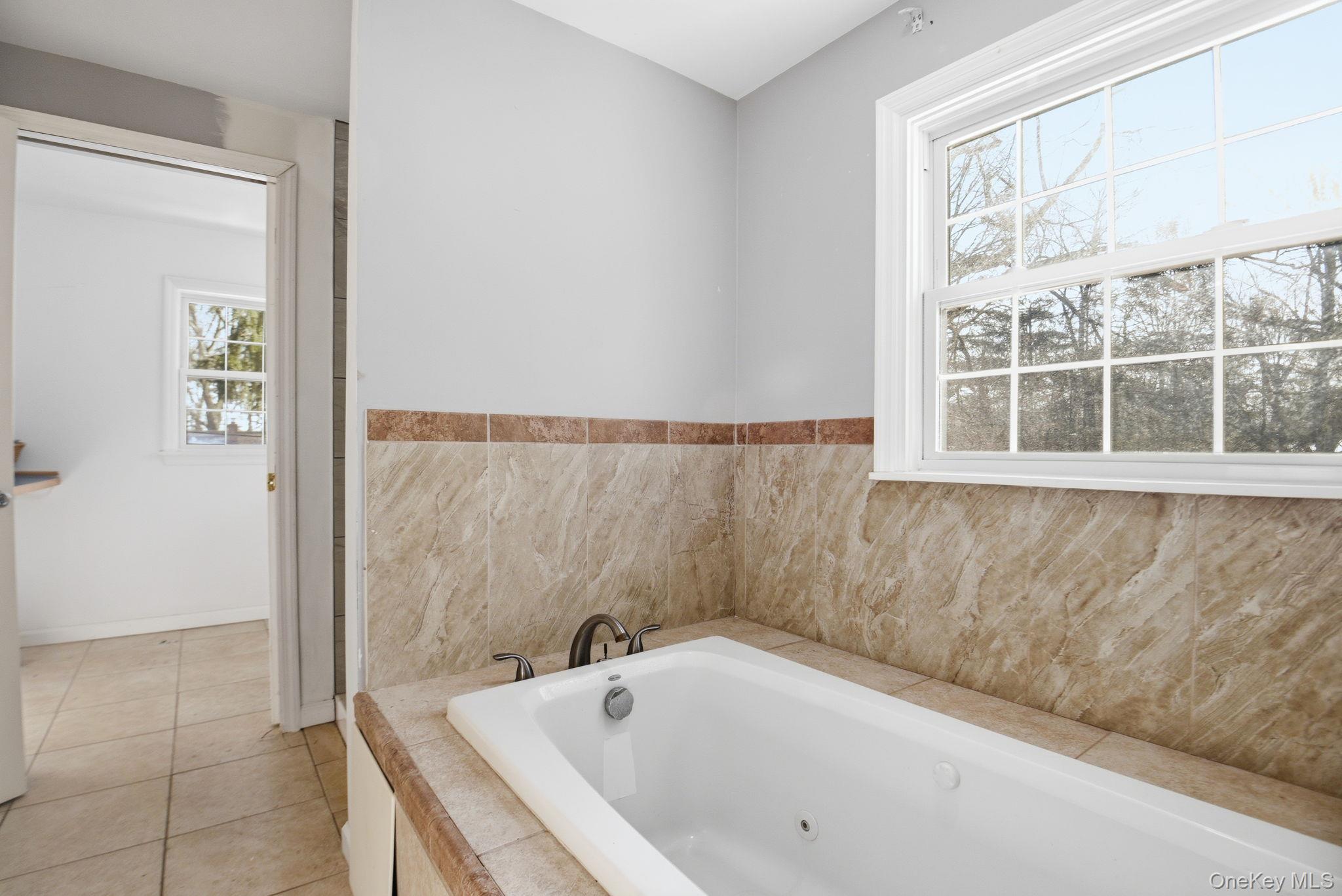 35 Shady Creek Road Pleasant Valley, NY 12569 - Photo 23 of 33 a bathroom with a bathtub and a window