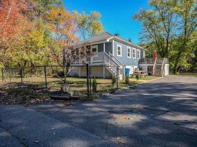 a view of house with a yard