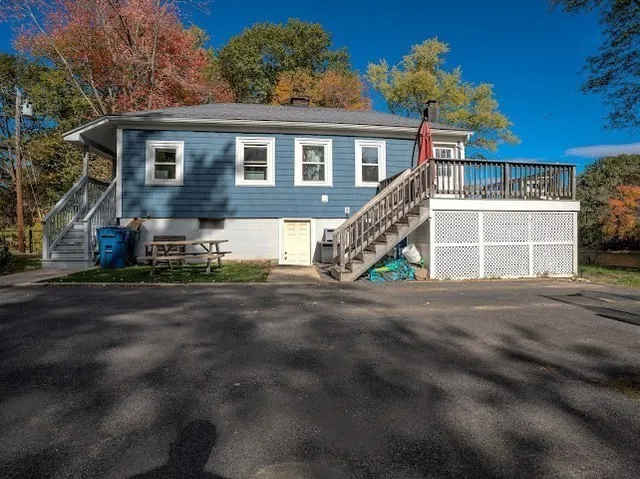 a view of a house with a big yard and large trees