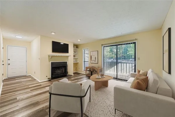 a living room with furniture large window and a fireplace