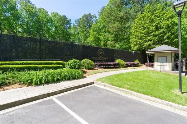 a view of a patio with table and chairs under an umbrella