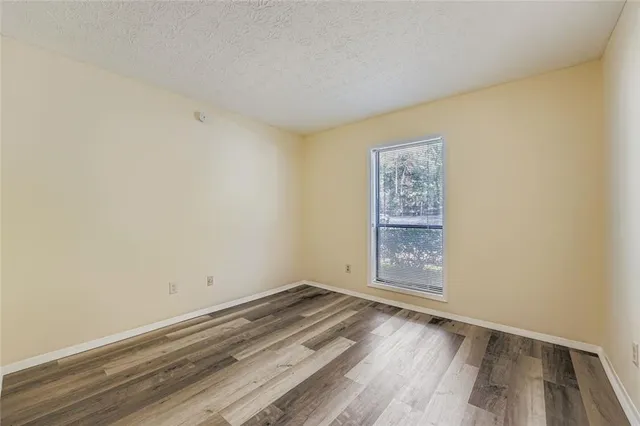 a view of room with wooden floor and window