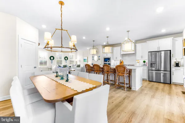 a kitchen with stainless steel appliances kitchen island granite countertop a sink a stove and refrigerator