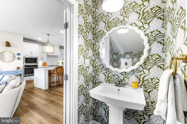 a living room with furniture and a dining table with wooden floor