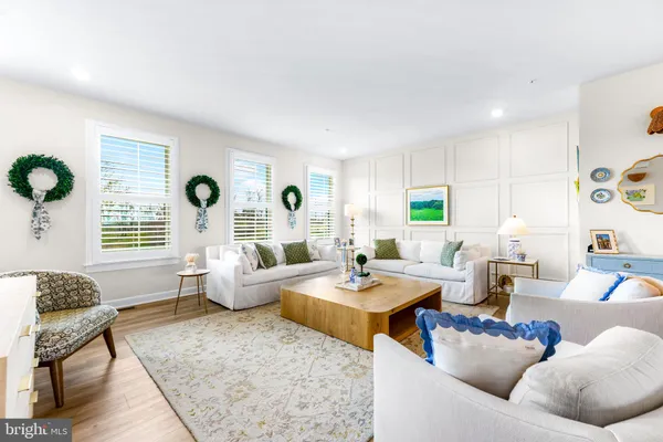 a living room with furniture and a painting on the wall