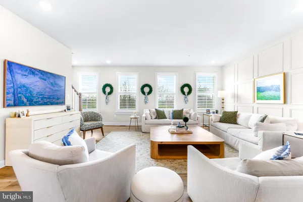 a view of a hallway with a white walls and wooden floor