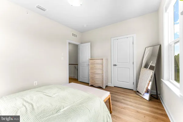 a bedroom with a bed and a mirror