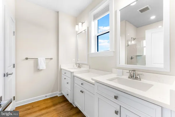 a front view of a building with a garden and plants