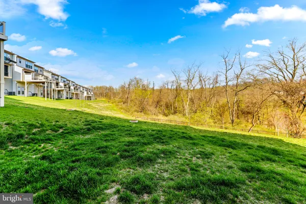 an aerial view of residential building with parking and ocean view