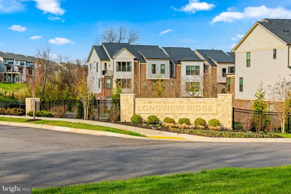 a view of yard with a building and trees in the background