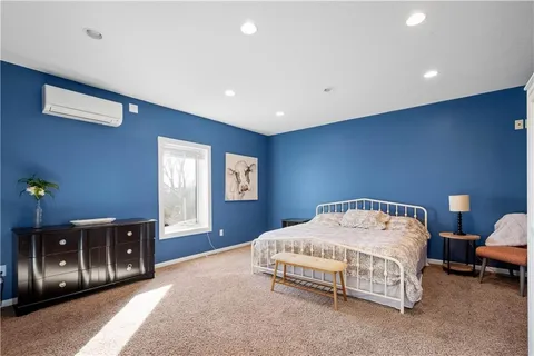 a bedroom with a bed couch and window