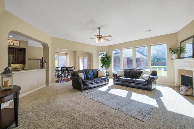 a view of a dining room with furniture a chandelier and wooden floor