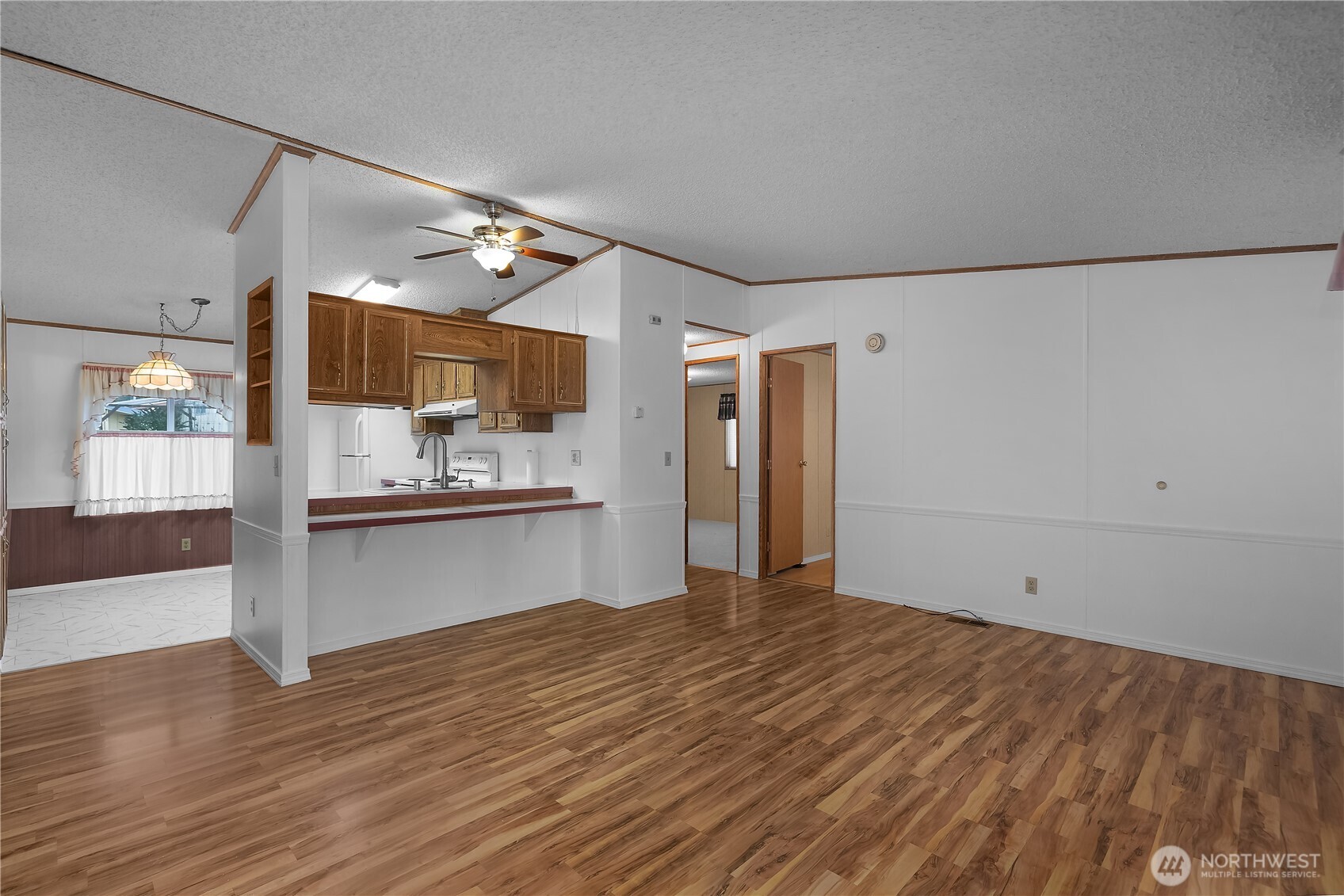 930 Trosper Road Southwest, Unit 78 Tumwater, WA 98512 - Photo 11 of 36 a open kitchen with white cabinets and wooden floor
