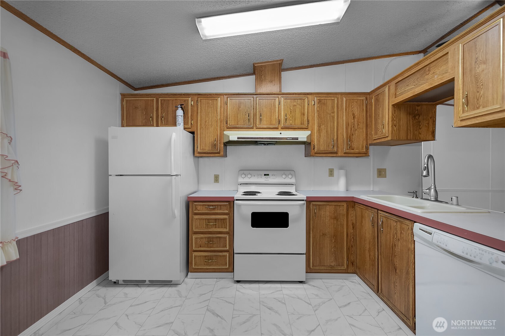 930 Trosper Road Southwest, Unit 78 Tumwater, WA 98512 - Photo 14 of 36 a kitchen with a stove sink and refrigerator