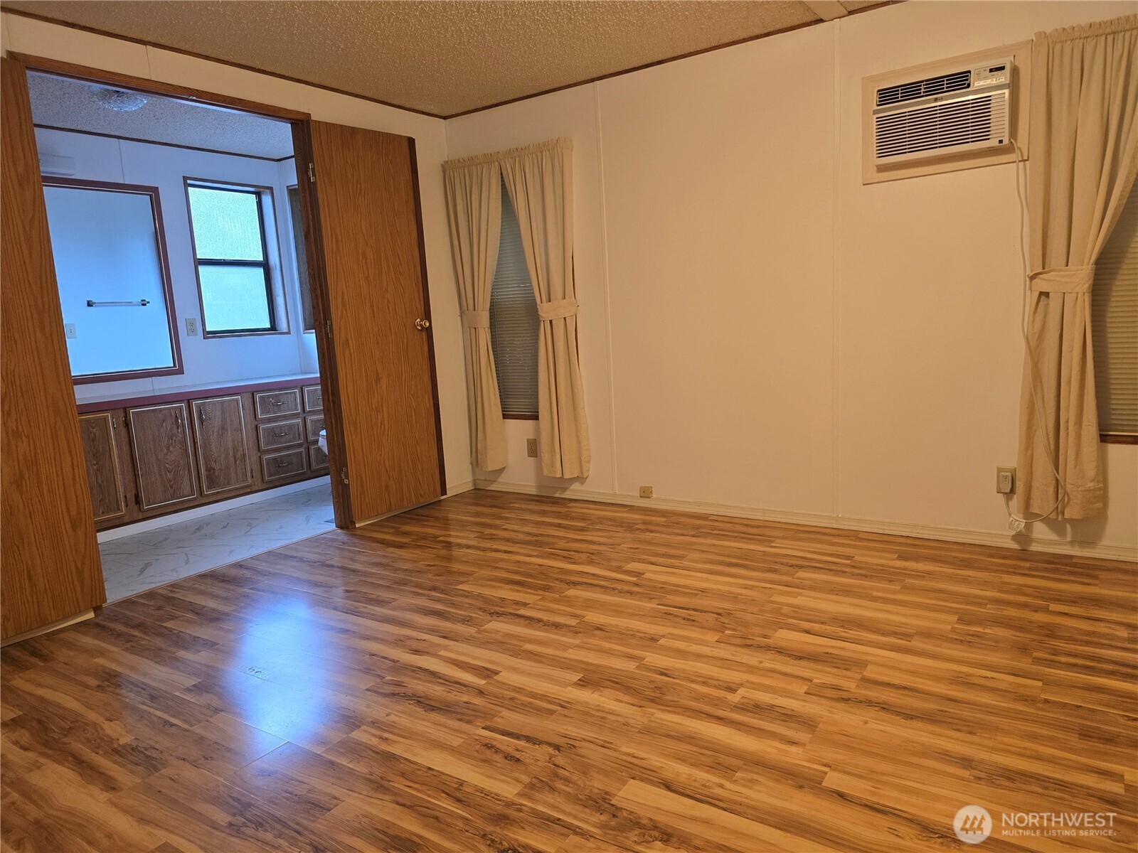 930 Trosper Road Southwest, Unit 78 Tumwater, WA 98512 - Photo 16 of 36 a view of empty room with wooden floor and fan