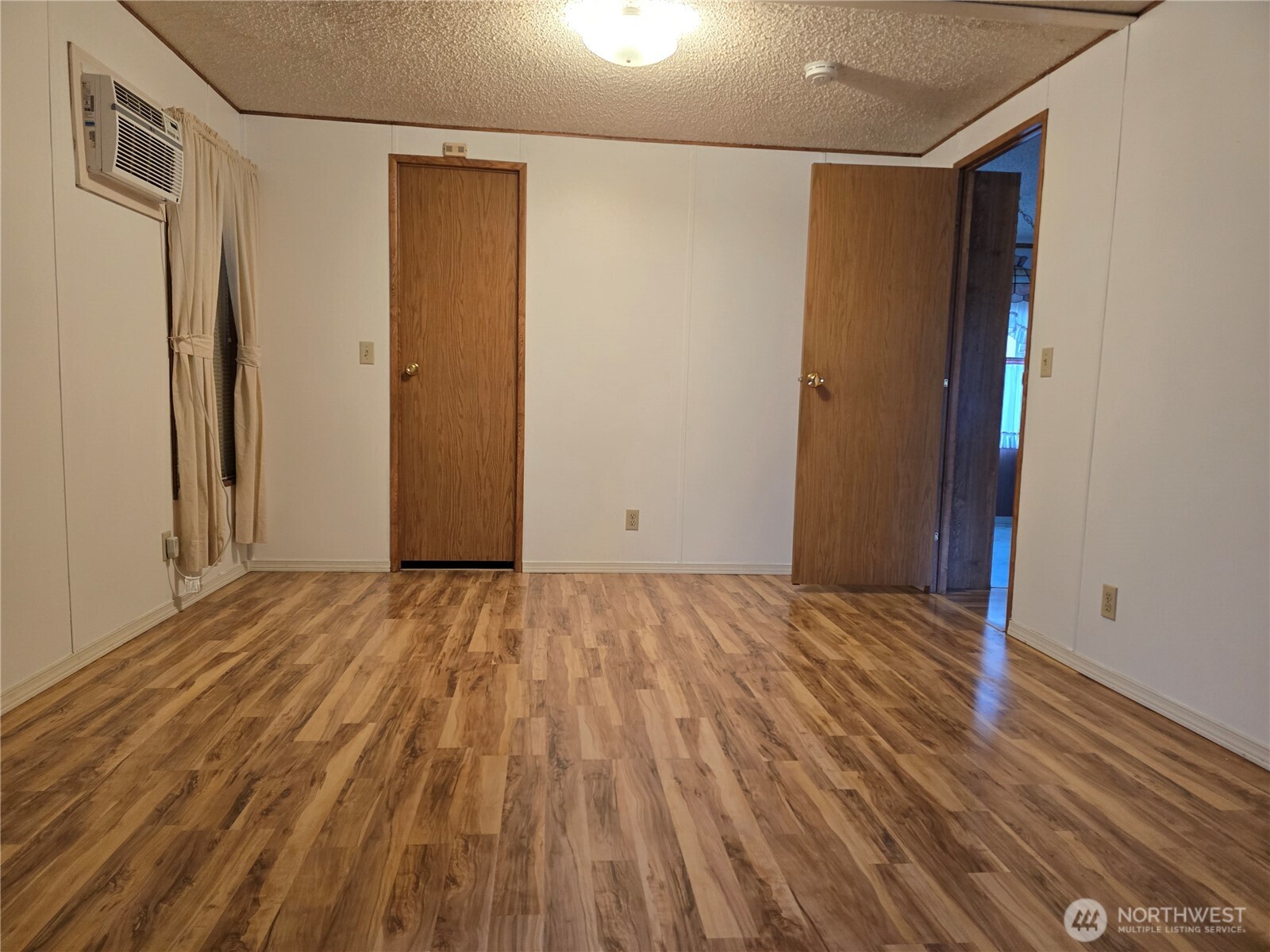 930 Trosper Road Southwest, Unit 78 Tumwater, WA 98512 - Photo 17 of 36 a view of an empty room with wooden floor