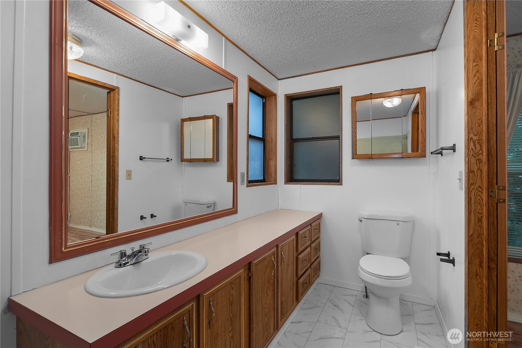 930 Trosper Road Southwest, Unit 78 Tumwater, WA 98512 - Photo 21 of 36 a bathroom with a toilet sink and mirror