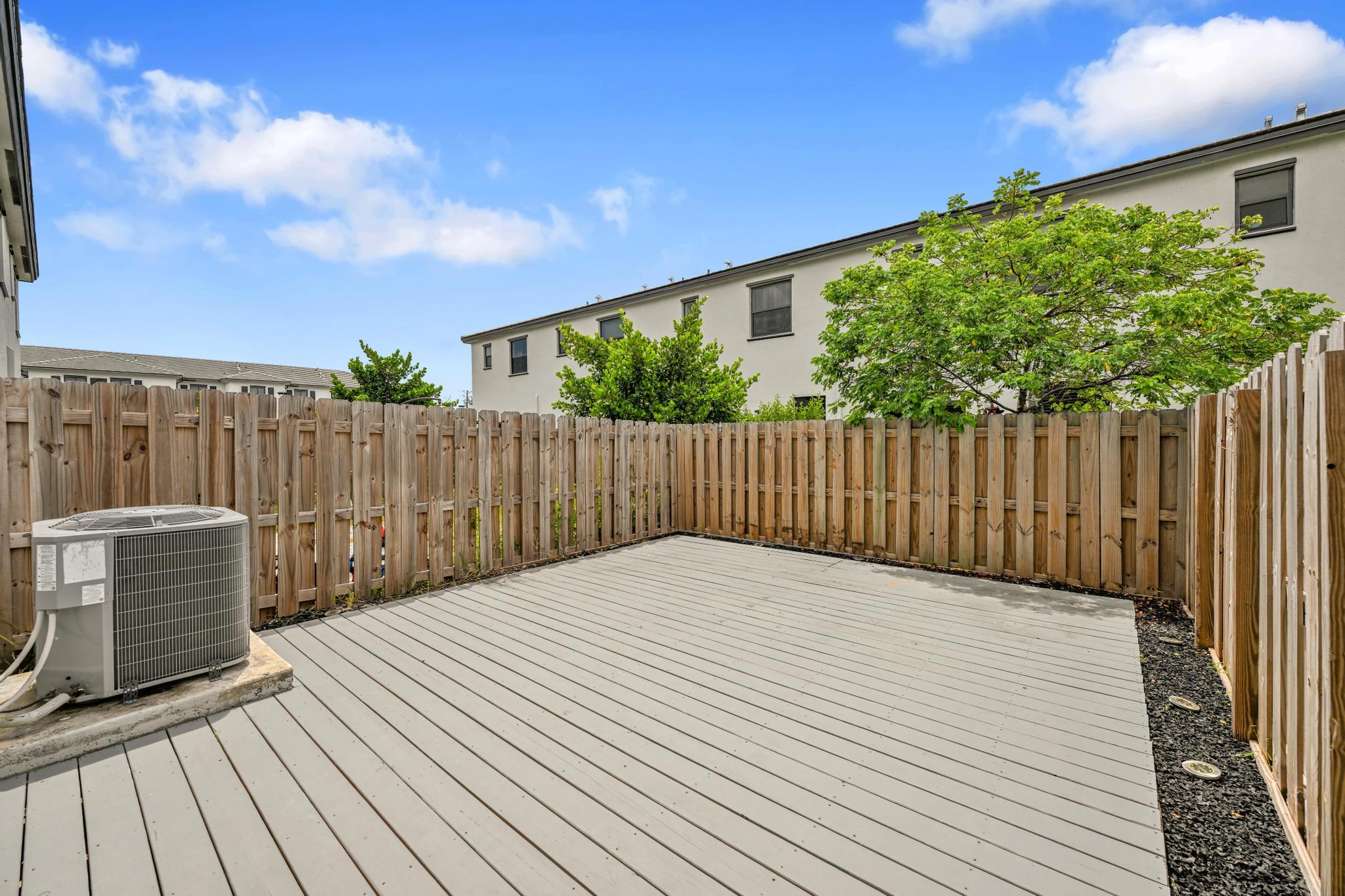 13234 Southwest 285th Street Homestead, FL 33033 - Photo 13 of 49 a balcony with wooden floor and fence