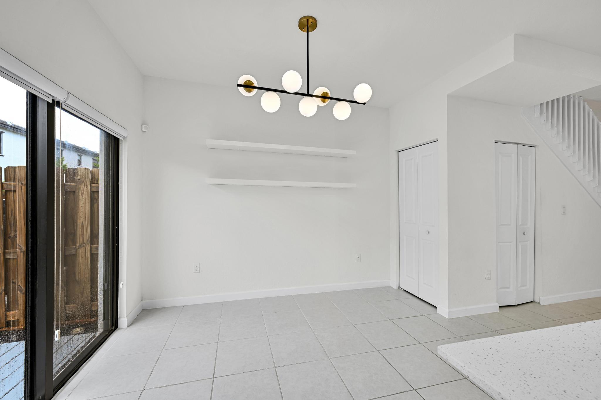 13234 Southwest 285th Street Homestead, FL 33033 - Photo 16 of 49 a view of an empty room with a chandelier