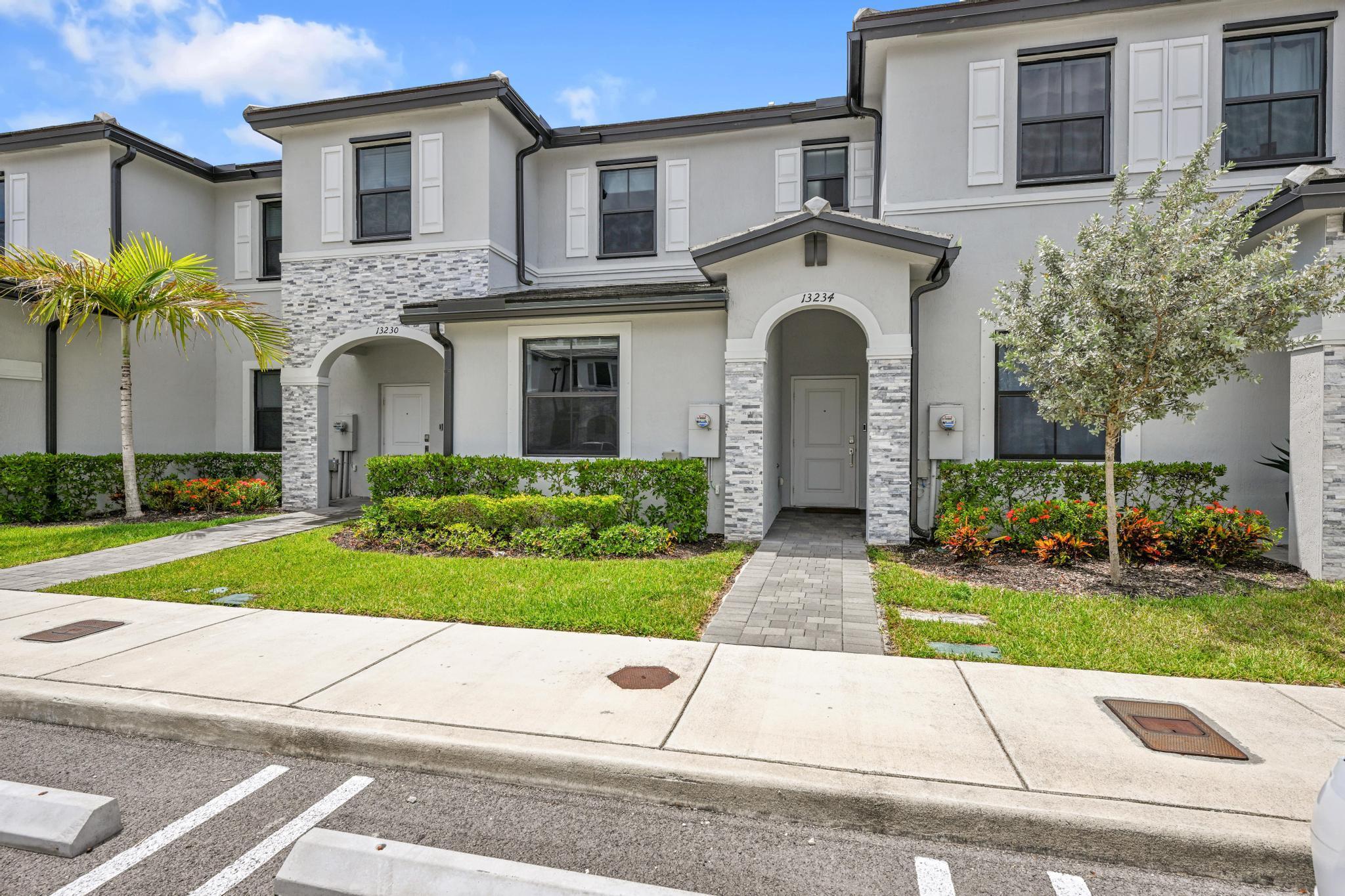 13234 Southwest 285th Street Homestead, FL 33033 - Photo 2 of 49 a front view of a house with a garden and plants