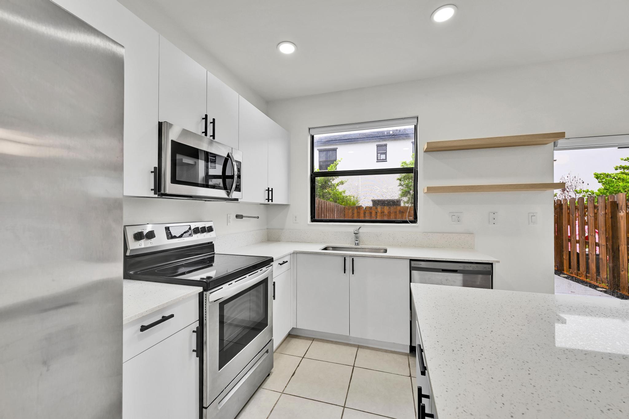 13234 Southwest 285th Street Homestead, FL 33033 - Photo 8 of 49 a kitchen with cabinets stainless steel appliances and wooden floor