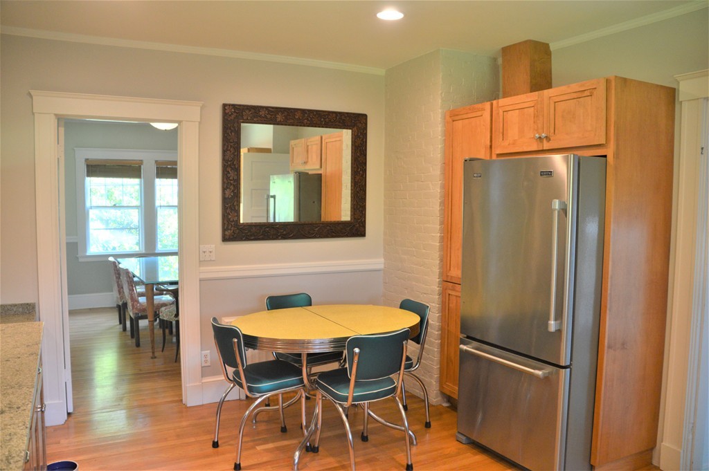 78 Walnut Street Needham, MA 02492 - Photo 11 of 24 a kitchen with stainless steel appliances refrigerator dining table and chairs