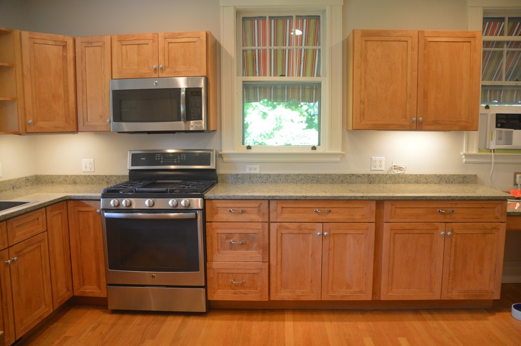 78 Walnut Street Needham, MA 02492 - Photo 10 of 24 a kitchen with granite countertop a stove and a microwave