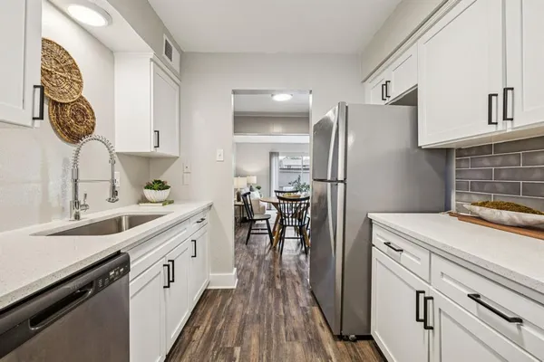a kitchen with a sink appliances and cabinets