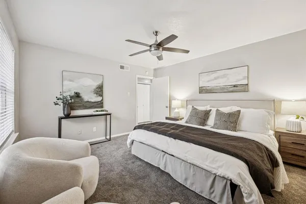 a bedroom with a bed and ceiling fan