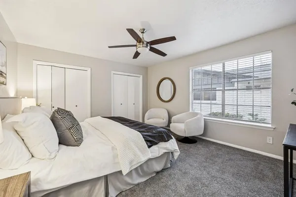a bedroom with bed and a window