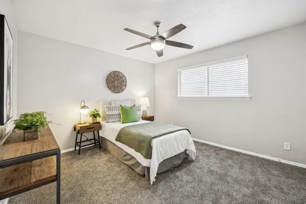 a bedroom with a bed and window