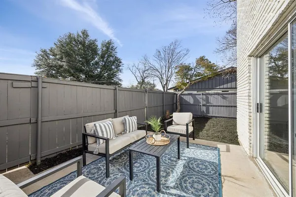 a view of a patio with a table and chairs